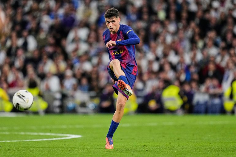 Barcelona's Pedri kicks the ball during a La Liga soccer match between Real Madrid and Barcelona in Madrid, Spain, Sunday, Oct. 26, 2025. (AP Photo/Bernat Armangue)