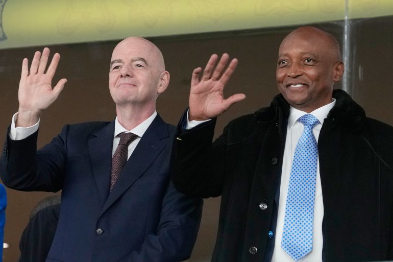 CAF President Patrice Motsepe and FIFA President Gianni Infantino wave from the tribune during the Africa Cup of Nations round of 16 soccer match between South Africa and Cameroon in Rabat, Morocco, Sunday, Jan. 4, 2026. (AP Photo/Themba Hadebe)