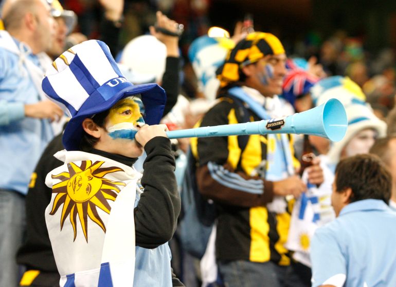 Football - Uruguay v France - FIFA World Cup South Africa 2010 - Group A - Green Point Stadium, Cape Town, South Africa - 11/6/10 Uruguay fans with face paint and vuvuzela Mandatory Credit: Action Images / Paul Thomas